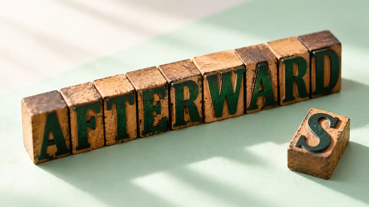 Wooden letterpress blocks spelling afterward with one extra S block set apart on a mint surface