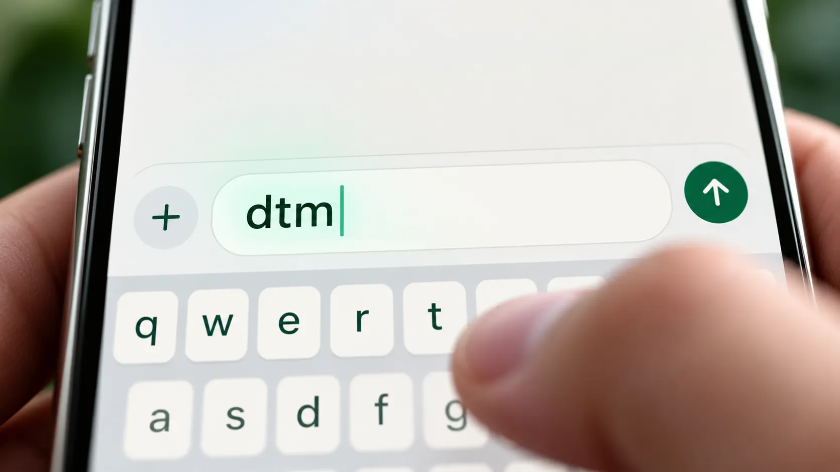 Close-up of the letters dtm typed in a phone message field for the dtm meaning in text